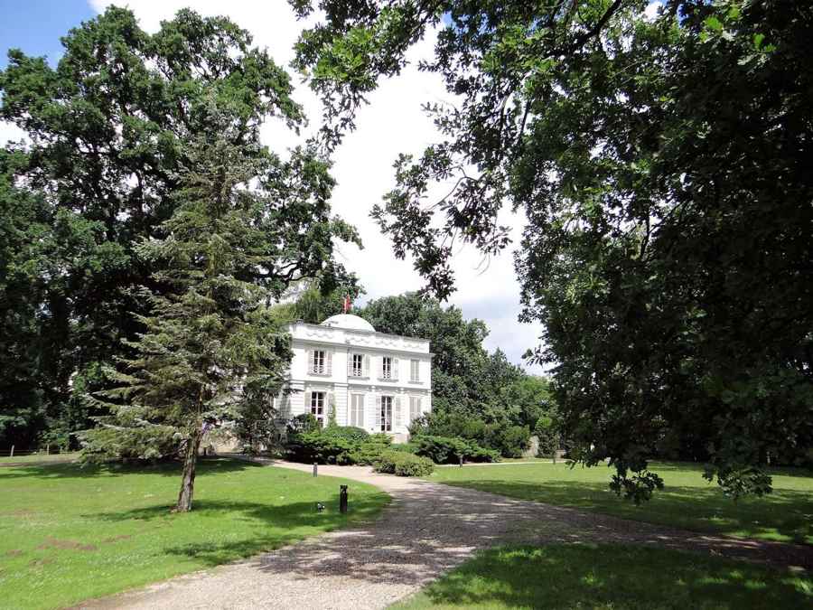 The palace at Natolin seen through park trees