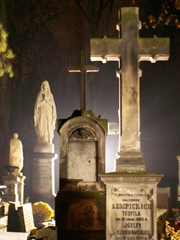 Powązki Cemetery in Warsaw at night during All Saints, with candles on the graves