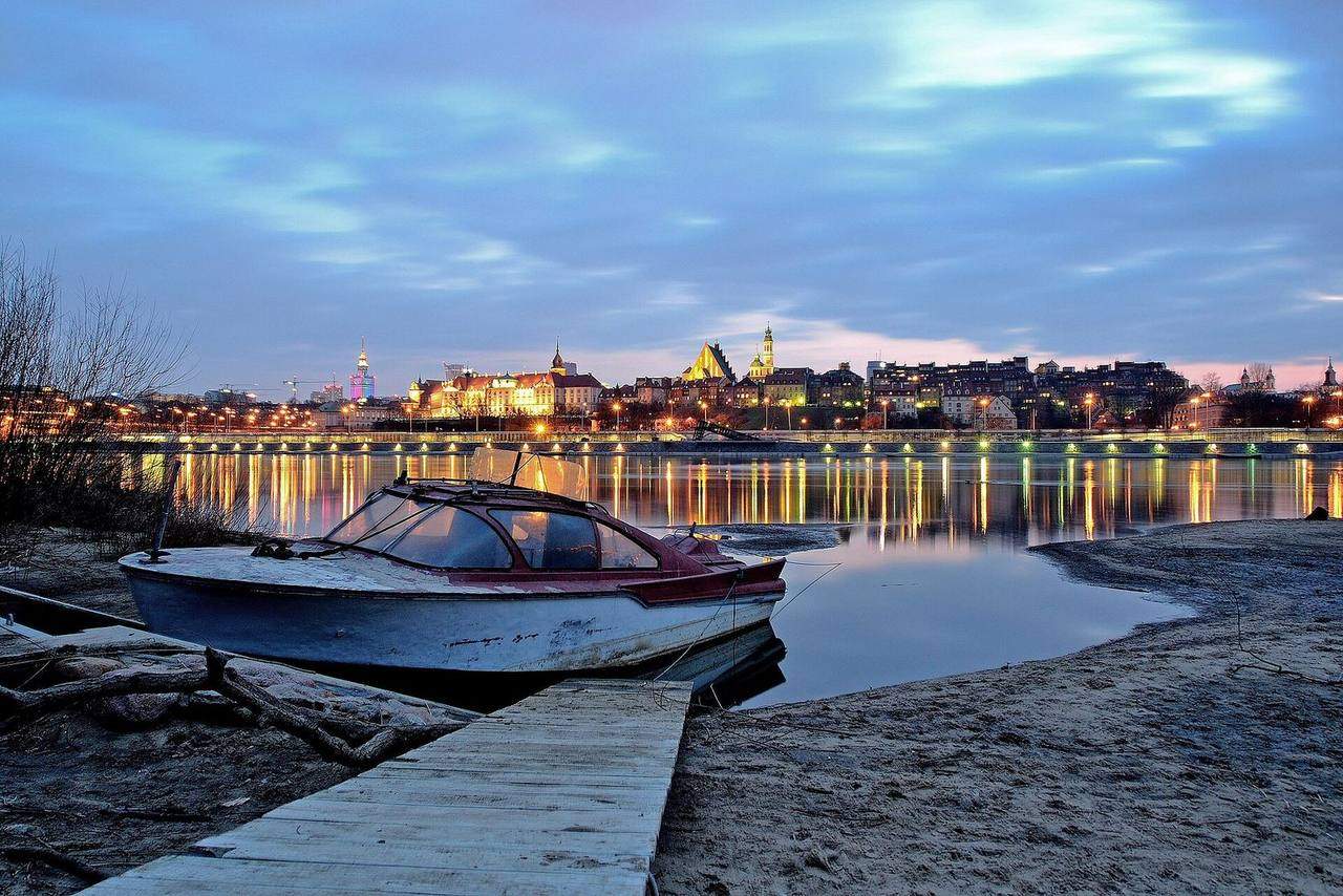 Sandy beach on the Vistula river in Warsaw with people relaxing